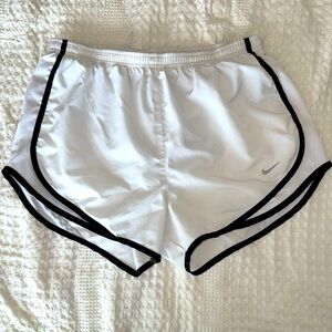 White Nike running shorts with black trim. Size medium.